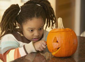 Girl carving pumpkin