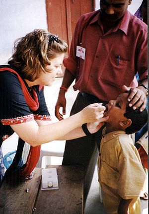 A child receives oral polio vaccine during a 2...