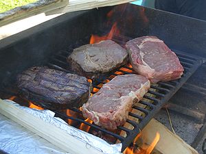 Large beef steaks over wood