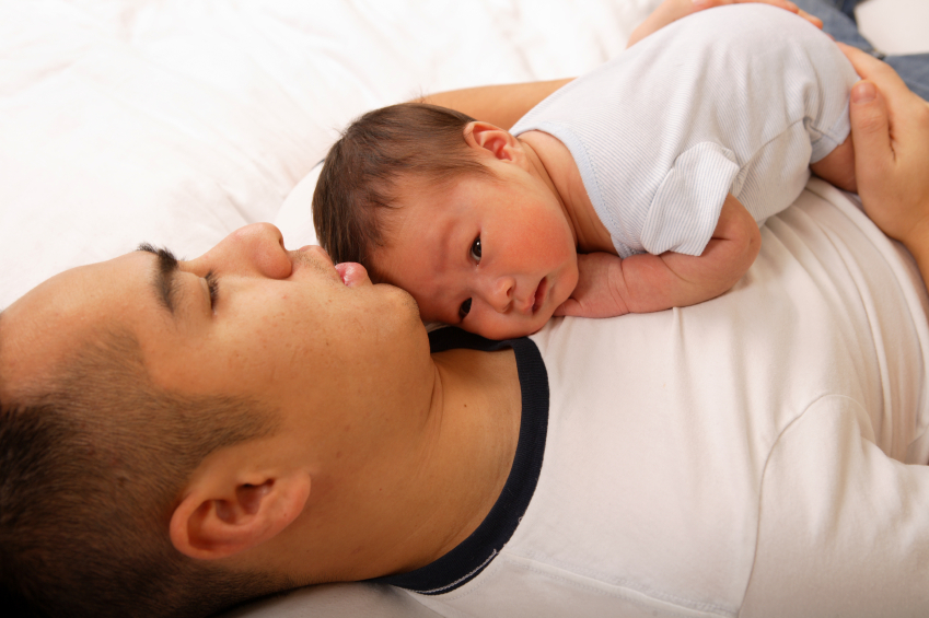 dad with baby on chest